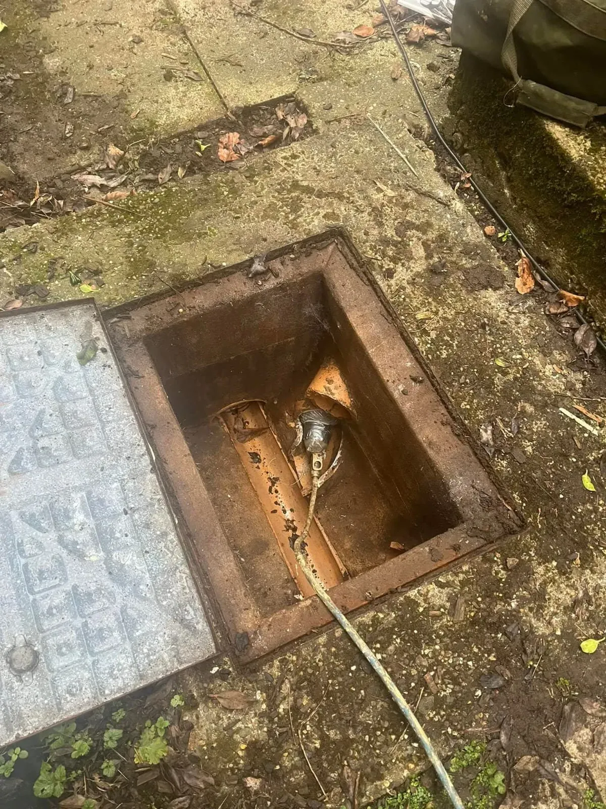 Drainage equipment being used in an open manhole.